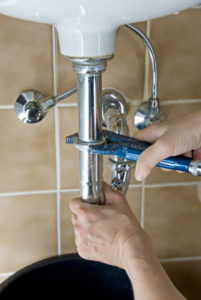 plumber fixing a leaking tap