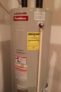 Tank-style water heater in home