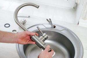 New sink faucet being installed.